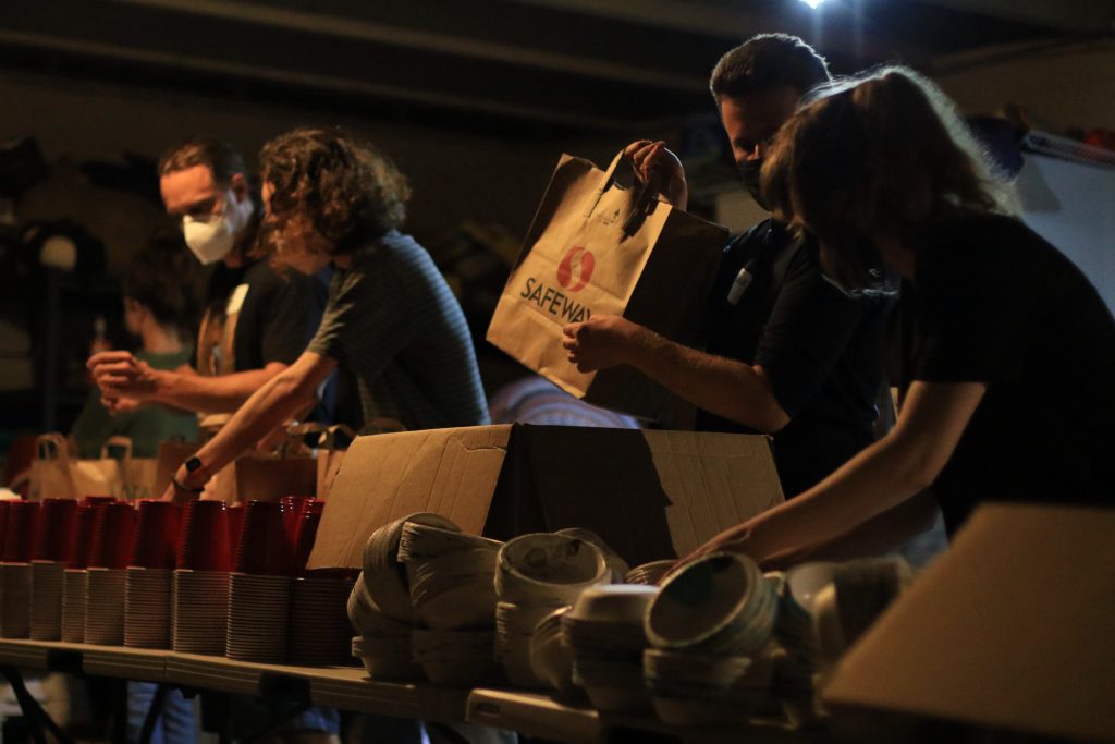 Volunteers pack supply bags for affected community members